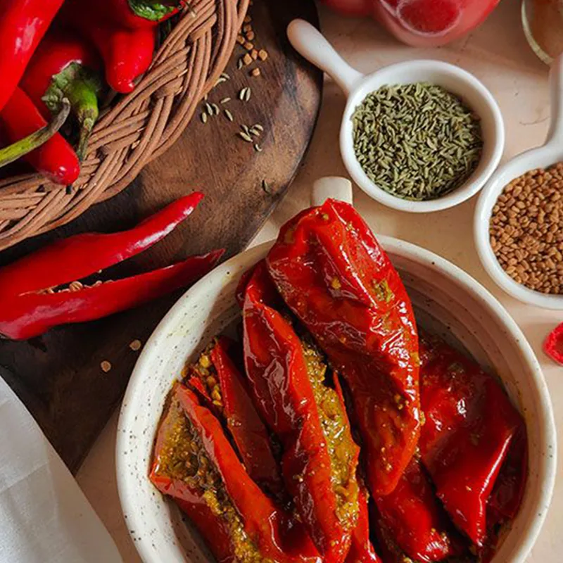 Stuffed red chillies with bowls of whole spices